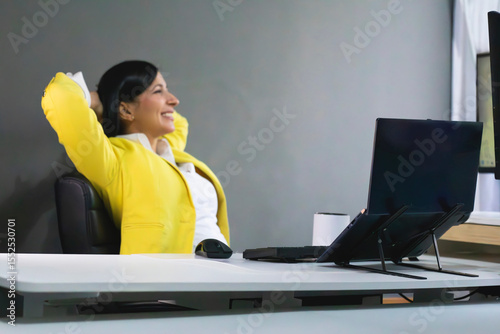 Blurred businesswoman relaxing at her desk after finishing work