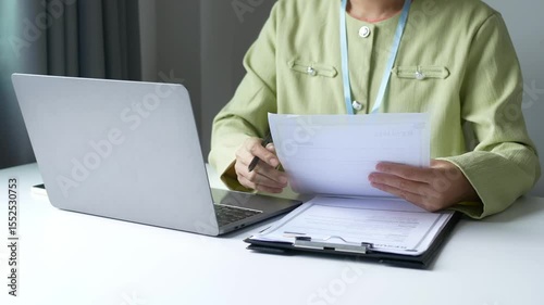 Businesswoman employer holding resume, recruiting, planning, evaluating and reviewing resume of job applicant, recruiting new employees, recruitment concept.