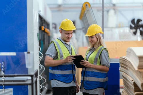 paper cardboard manufacture factory concept, industry worker person working with machine to recycling material package box in warehouse storage or plant production for global logistic business