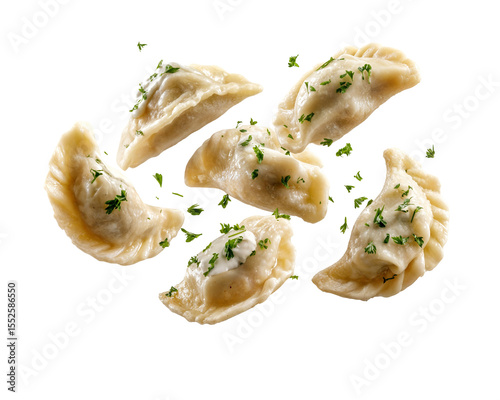 Traditional Polish pierogi dumplings with sour cream and parsley garnish floating isolated on transparent background