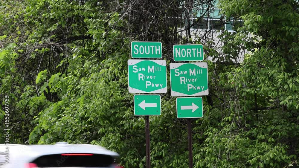 cars pass under saw mill parkway highway south and north road signs (signage sign signal arrow) westchester county new york state