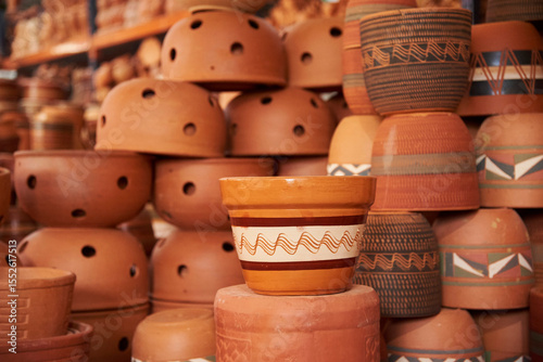Ceramic pottery pots with different designs stacked for sale in Raquira, Boyaca, Colombia, a tourist town known for its handmade ceramic products.