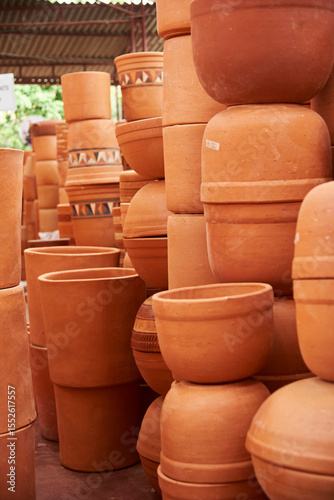 Ceramic pottery pots with different designs stacked for sale in Raquira, Boyaca, Colombia, a tourist town known for its handmade ceramic products.