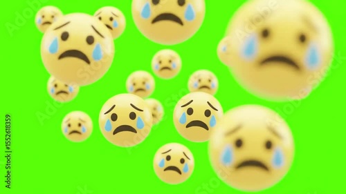 Multiple 3d rendered sad emojis with tears falling on a green background