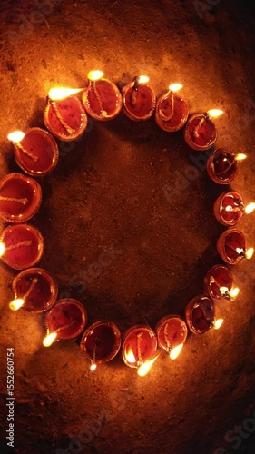 Vertical video of Indian festival Diwali, Closeup Festival Diya or Oil Lamp with Glowing Flame, diwali festive of light celebration background animation for social media story.
