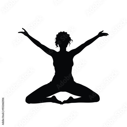 Silhouette of a woman practicing yoga with her arms raised high