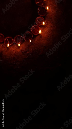 Vertical video of Indian festival Diwali, Closeup Festival Diya or Oil Lamp with Glowing Flame, diwali festive of light celebration background animation for social media story.
