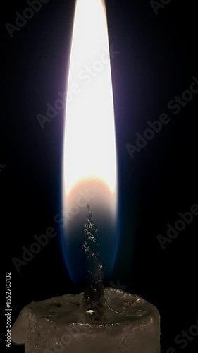 Closeup candle fire flame isolated burning on black background, celebration background for social media story.