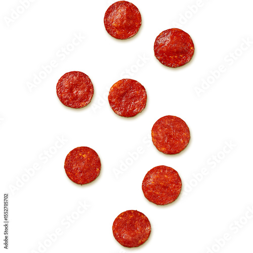 A collection of round slices of pepperoni arranged on a white background.
