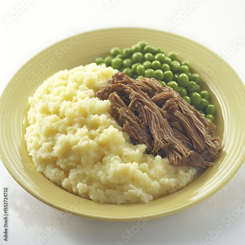 Delicious plate featuring mashed potatoes, pulled pork, and fresh green peas