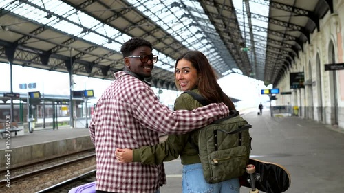 Young tourists couple walking in train station