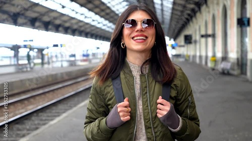 Tourist woman smiling at train station platform