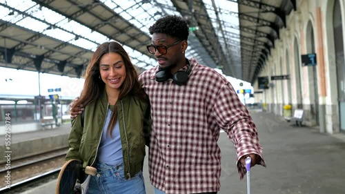 Young tourists couple walking in train station