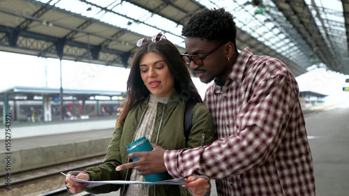 Young tourists consulting map in train station