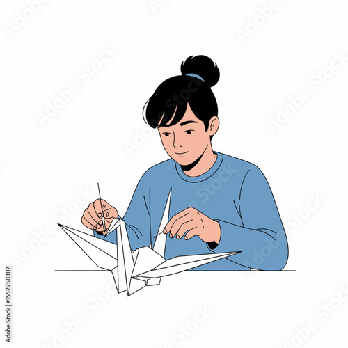 Young person focused on crafting delicate paper origami crane with meticulous detail