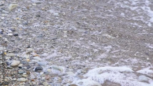 a wave washes a pebble beach. Sea Waves Washes Pebble Beach. Sea Waves Roll Ashore. Nature Concept. 