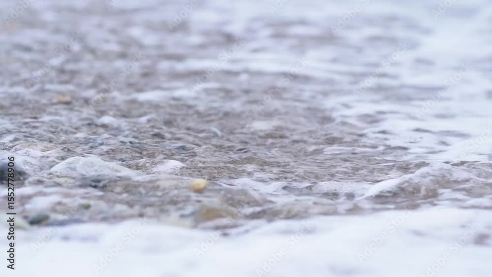 a wave washes a pebble beach. Sea Waves Washes Pebble Beach. Sea Waves Roll Ashore. Nature Concept. 