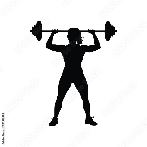 Silhouette of a strong athletic woman lifting a heavy barbell overhead