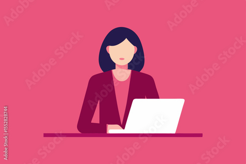 Smiling businesswoman works on a laptop at her office desk
