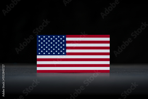 Minimal studio shot of the American flag on black background