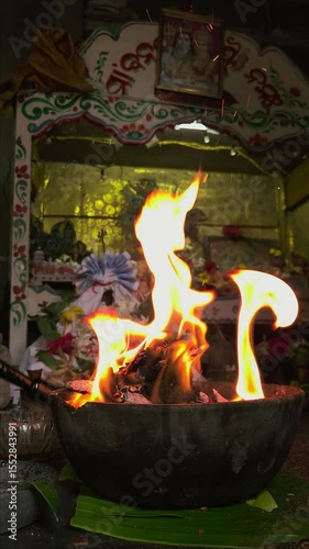 Traditional Hindu fire ceremony with sacred statues, symbolizing devotion during Diwali or other spiritual festivals. spiritual vertical background.