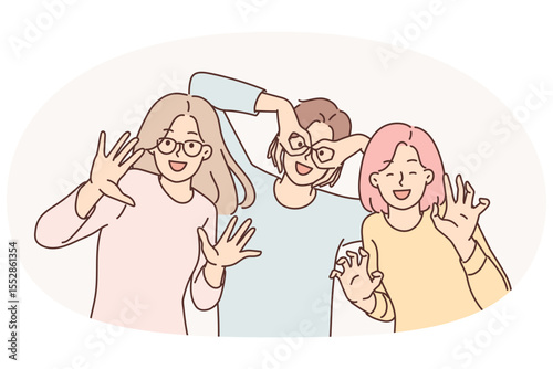 Happy girls of friend have fun making funny faces and putting fingers to faces instead of glasses