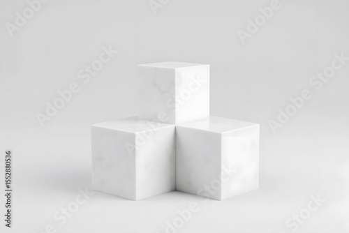 group of three white marble pedestals sitting next to each other