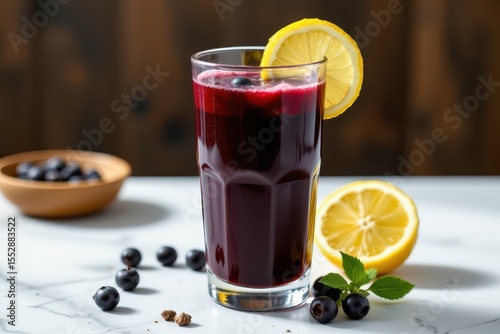 a glass of glowing elderberry and lemon juice blend, emphasizing immune support and antiviral properties.