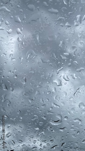raindrops on Glass Window with Dark Cloudy Sky Background. rainy season or weather concept.