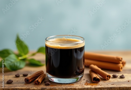 a refreshing glass of glowing black coffee with cinnamon, highlighting appetite suppression and metabolism boost.
