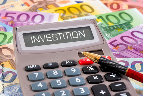 Ein Taschenrechner steht auf vielen Euro Banknoten und im Display steht das Wort Investition