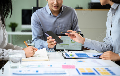 Business documents on office table with smart phone and calculator digital tablet and graph business with social network diagram