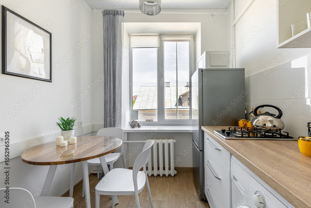 Fototapeta premium Bright Kitchen with Dining Table, Window and Wooden Countertop