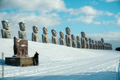 Moai, big stone statue in winter with snow on ground at hill of Buddha