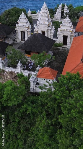 Aerial view of Hindu temple at Indian Ocean coastline of beautiful island of gods.Nusa Dua.Bali.Indonesia.Vertical video