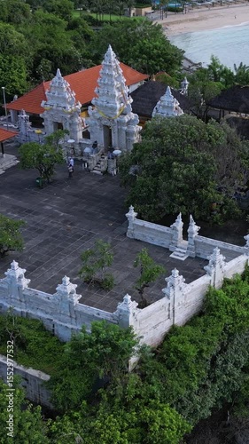 Aerial view of Hindu temple at Indian Ocean coastline of beautiful island of gods.Nusa Dua.Bali.Indonesia.Vertical video