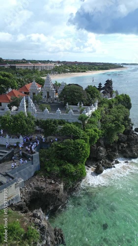 Aerial view of Hindu temple at Indian Ocean coastline of beautiful island of gods.Nusa Dua.Bali.Indonesia.Vertical video