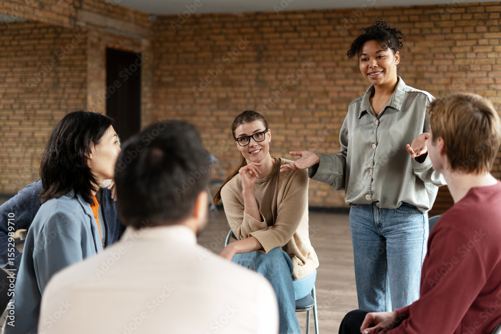 Fototapeta premium Young business coach leading a team meeting in a modern office