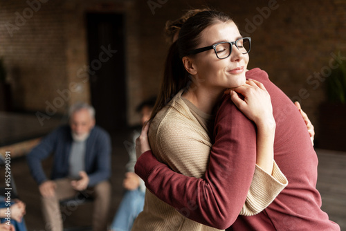 Obraz na plátně Woman is hugging a man during group therapy session