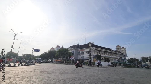 Riding Bike Across City Square Near Building in Clear Weather