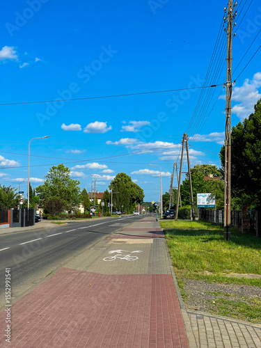 Wallpaper Mural Scenic road crossing a bridge through a lush green mountain landscape in Poland. Cars and a truck traveling along the route surrounded by dense forest and hills. Torontodigital.ca