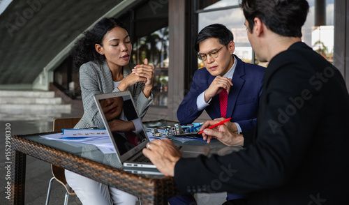 Latino man, African American businessperson, Asian manager brainstorming startup small business strategy. Multiracial businesswoman and colleague serious working on planning. Diversity people team.