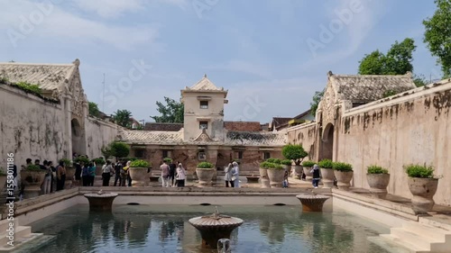 Visiting Historical Site with Water Pool and Tower on a Sunny Day