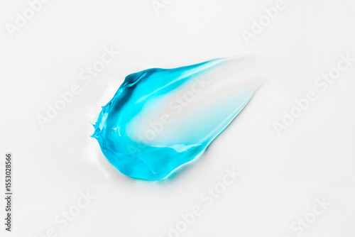A smear of blue cosmetic hair gel on a white background