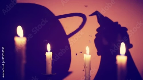 Halloween shadows of candles and cauldron on wall at night  