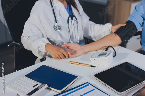 Doctor checking patient arterial blood pressure in hospital. Health care Concept