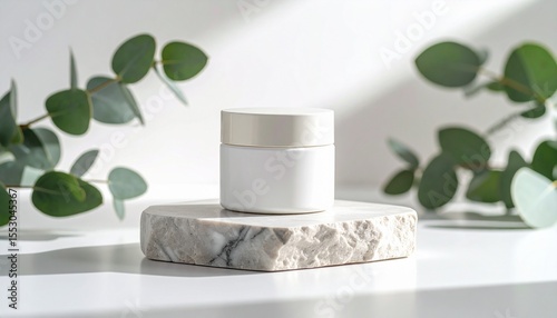 Minimalist skincare moisturizer jar mockup placed on a smooth stone pedestal with eucalyptus leaves and sunlight, clean background, organic branding style, product advertising