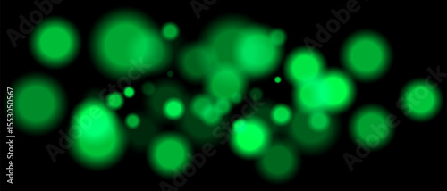 Green blurred bokeh particles with varying size and opacity on black background. Abstract design element for festive or sci-fi scenes.