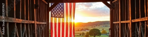 American flag hanging in barn with scenic sunrise in the background