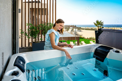 Travel moment with woman enjoying private rooftop jacuzzi with sea view. Luxury vacation lifestyle captured in peaceful outdoor setting.